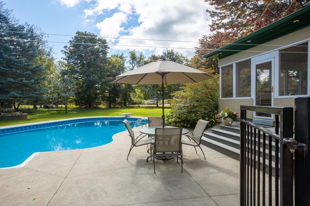 Black powder-coated aluminum pool-code fence surrounding a McNairy County back yard pool