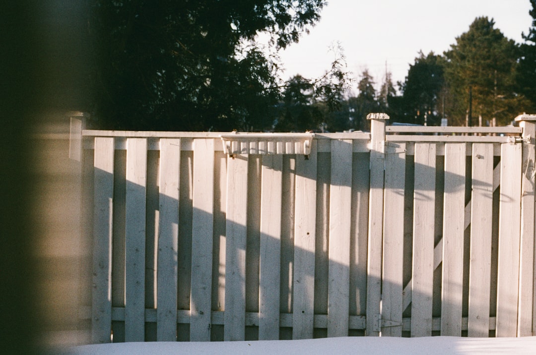 White vinyl privacy fence newly installed in a McNairy County residential back yard